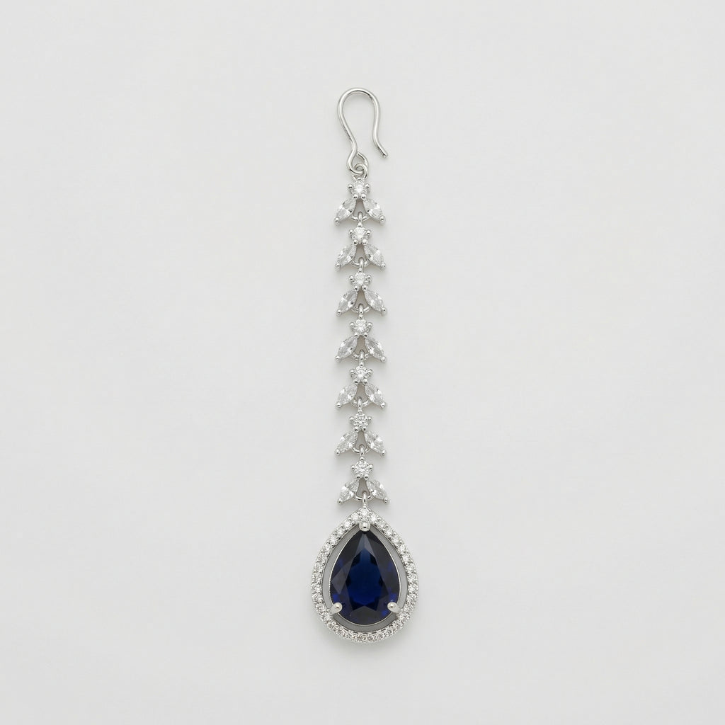 Onyx Halo Drop Tikka silver-tone maang tikka with dark blue teardrop pendant and clear halo on gray background