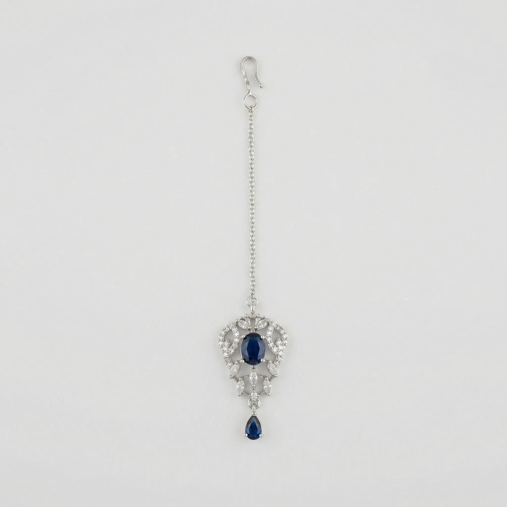 Sapphire Drop Crystal Tikka silver maang tikka with navy blue center stone on gray background