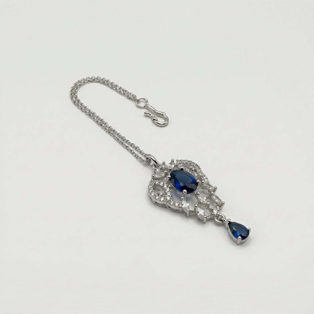 Sapphire Drop Crystal Tikka detail showing oval navy center, clear pavé frame, and navy teardrop drop