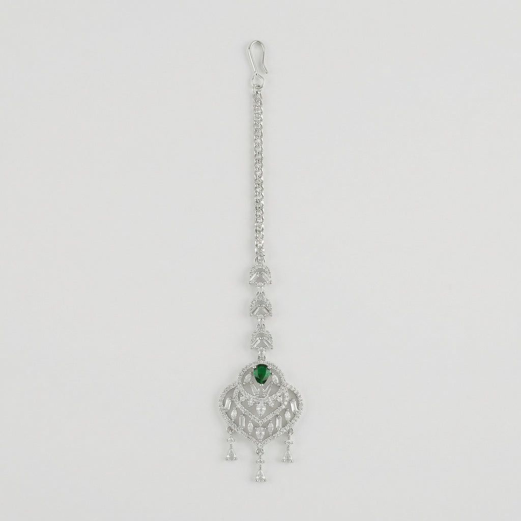 Emerald Grace Tikka silver-tone maang tikka with emerald-green pear center and clear stone frame on gray background