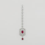 Rani Ruby Tikka silver maang tikka with ruby-red rectangular center stone on gray background
