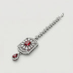 Rani Ruby Tikka detail showing floral crystal chain, ruby center, and ruby teardrop drop