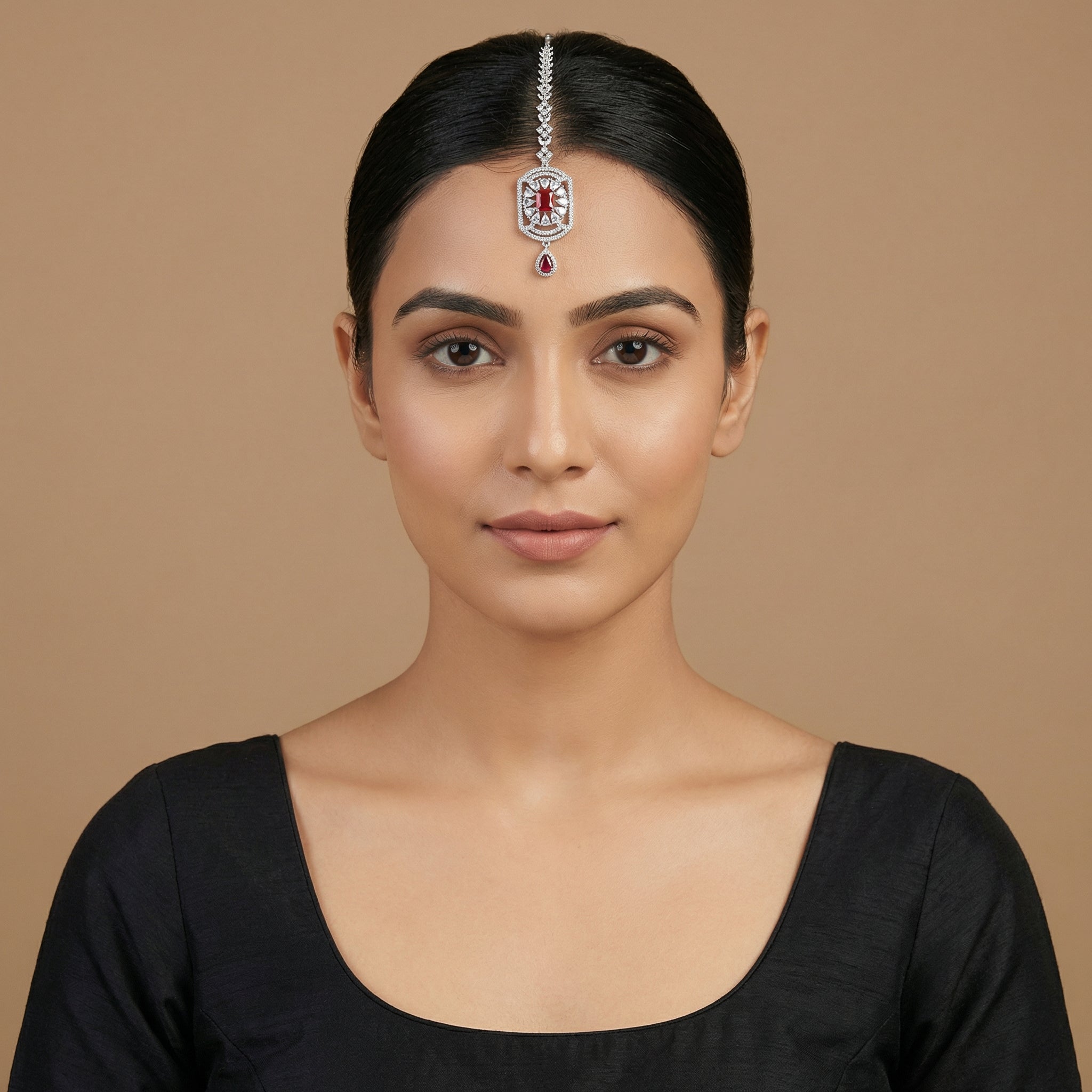 Rani Ruby Tikka detail showing floral crystal chain, ruby center, and ruby teardrop drop
