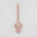 Blush Rosette Drop Tikka rose gold maang tikka with filigree round pendant and pink bead drops on gray background