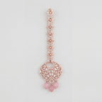 Blush Rosette Drop Tikka rose gold maang tikka with filigree round pendant and pink bead drops on gray background