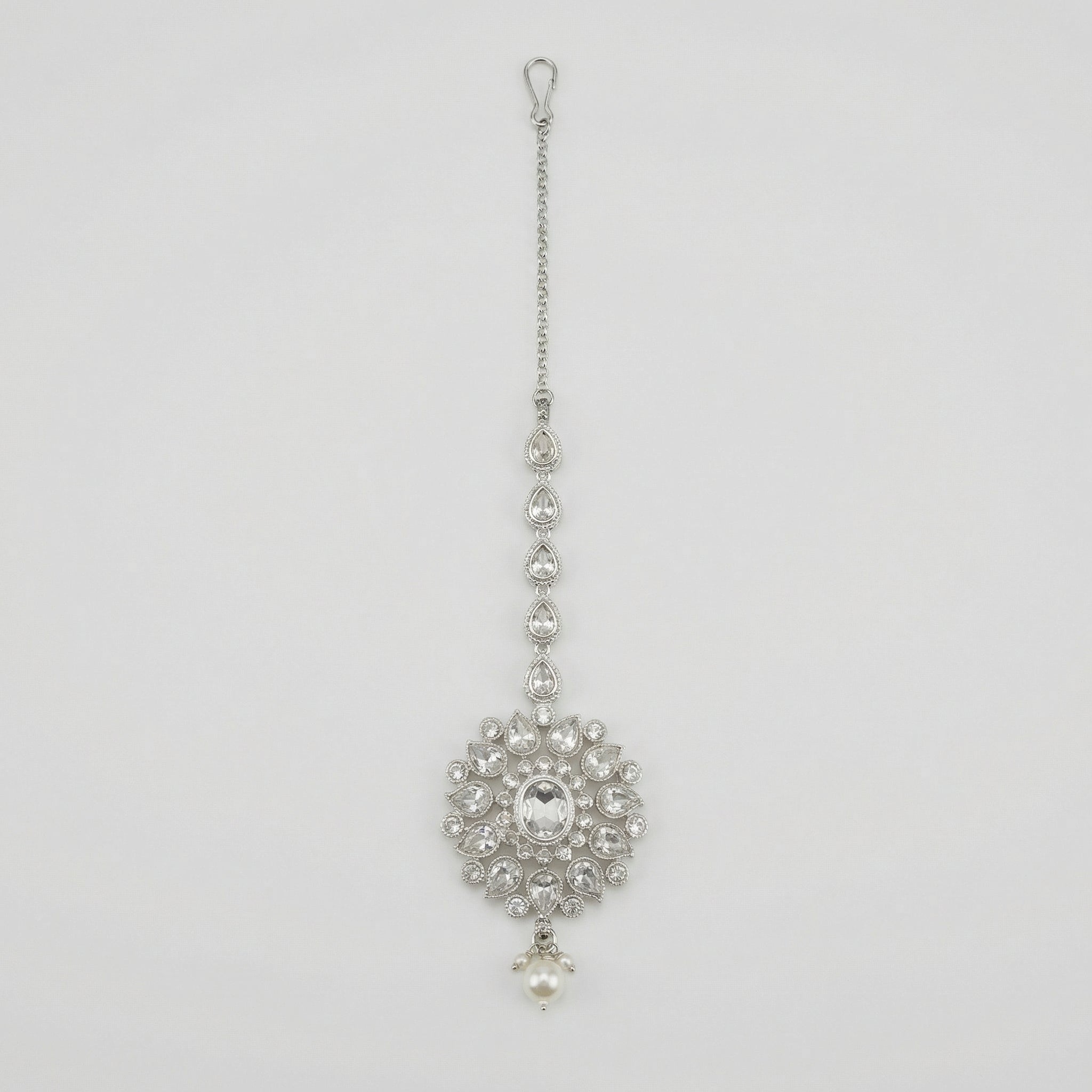 Silver Flora Pearl Tikka silver maang tikka with floral crystal pendant and pearl drop on gray background