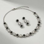 Zehra Onyx Halo Necklace Set necklace detail with black halo accents and matching earrings, flatlay