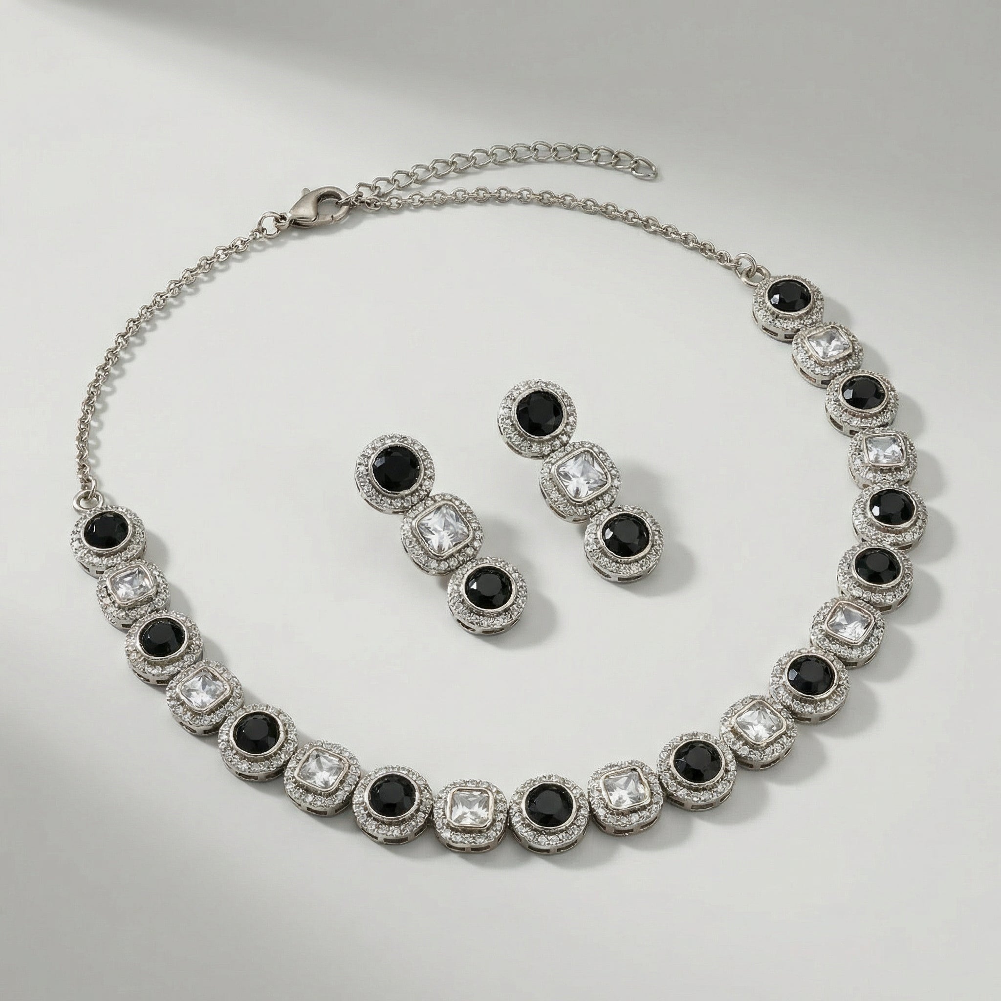 Zehra Onyx Halo Necklace Set necklace detail with black halo accents and matching earrings, flatlay