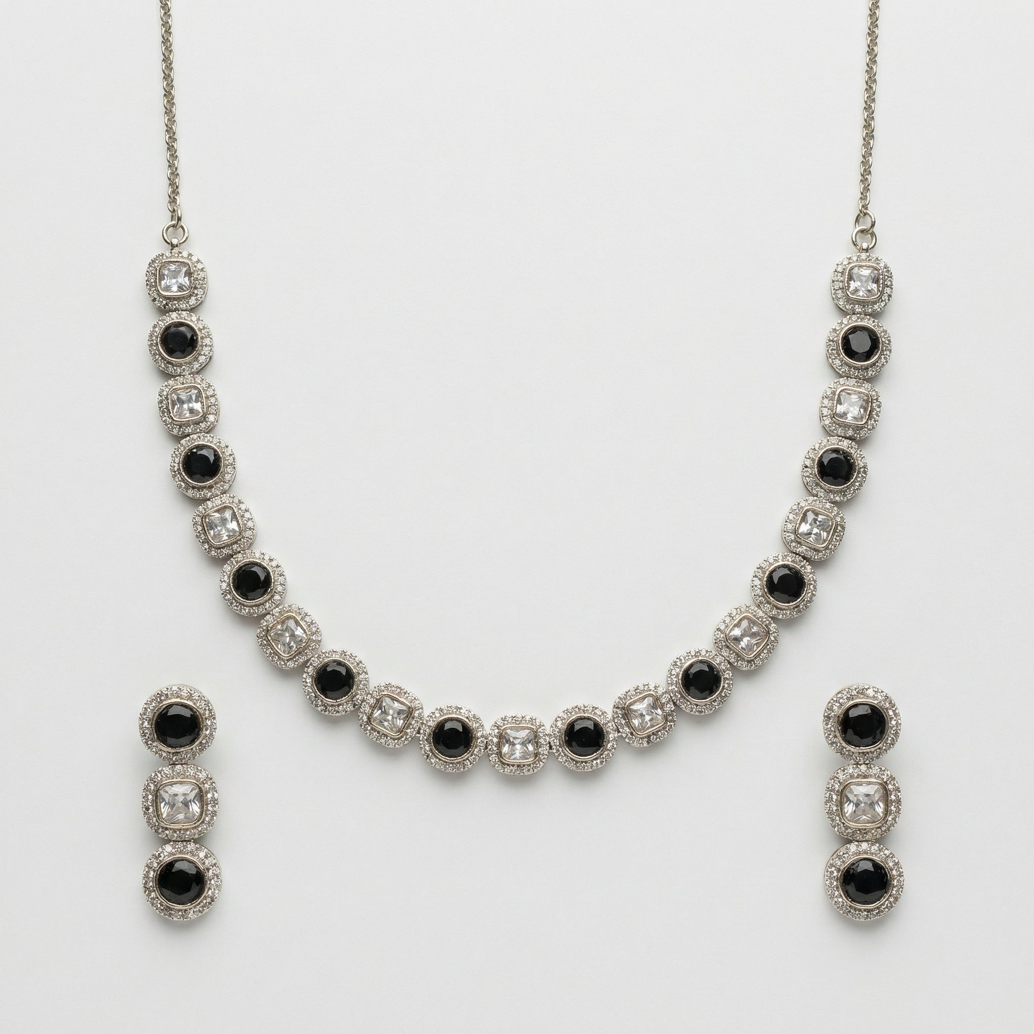 Zehra Onyx Halo Necklace Set necklace with matching earrings, studio flatlay