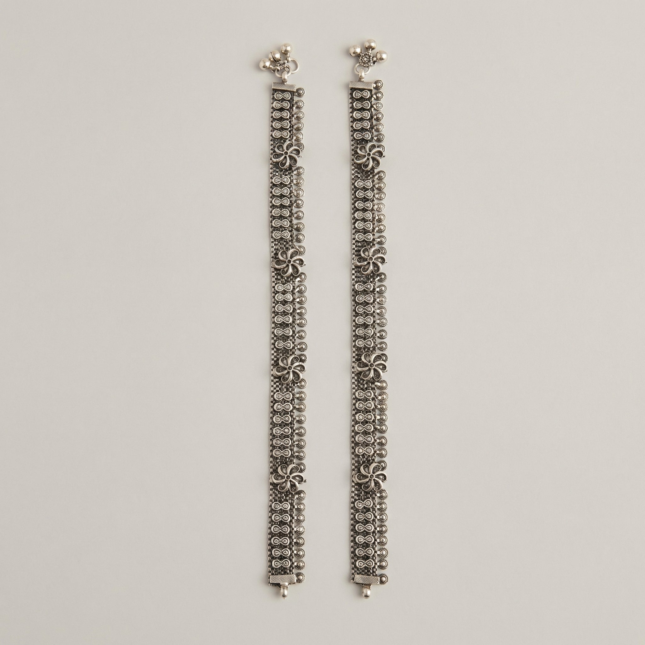Oxidized Floral Payal detail showing infinity-link band ghungroo bells and textured floral studs