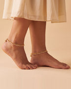 Matching Priya Pearl Anklets worn as a pair, gold-tone chain with off-white pearl drops and tiny bells