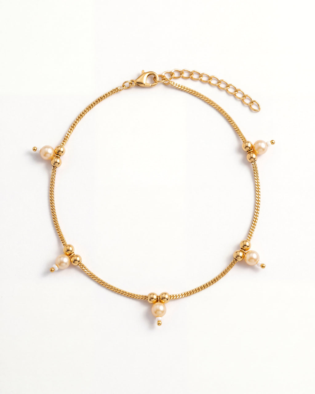 Sia Pearl Anklet laid in an oval, gold-tone chain with cream pearl drops, 2 inch extension and lobster clasp