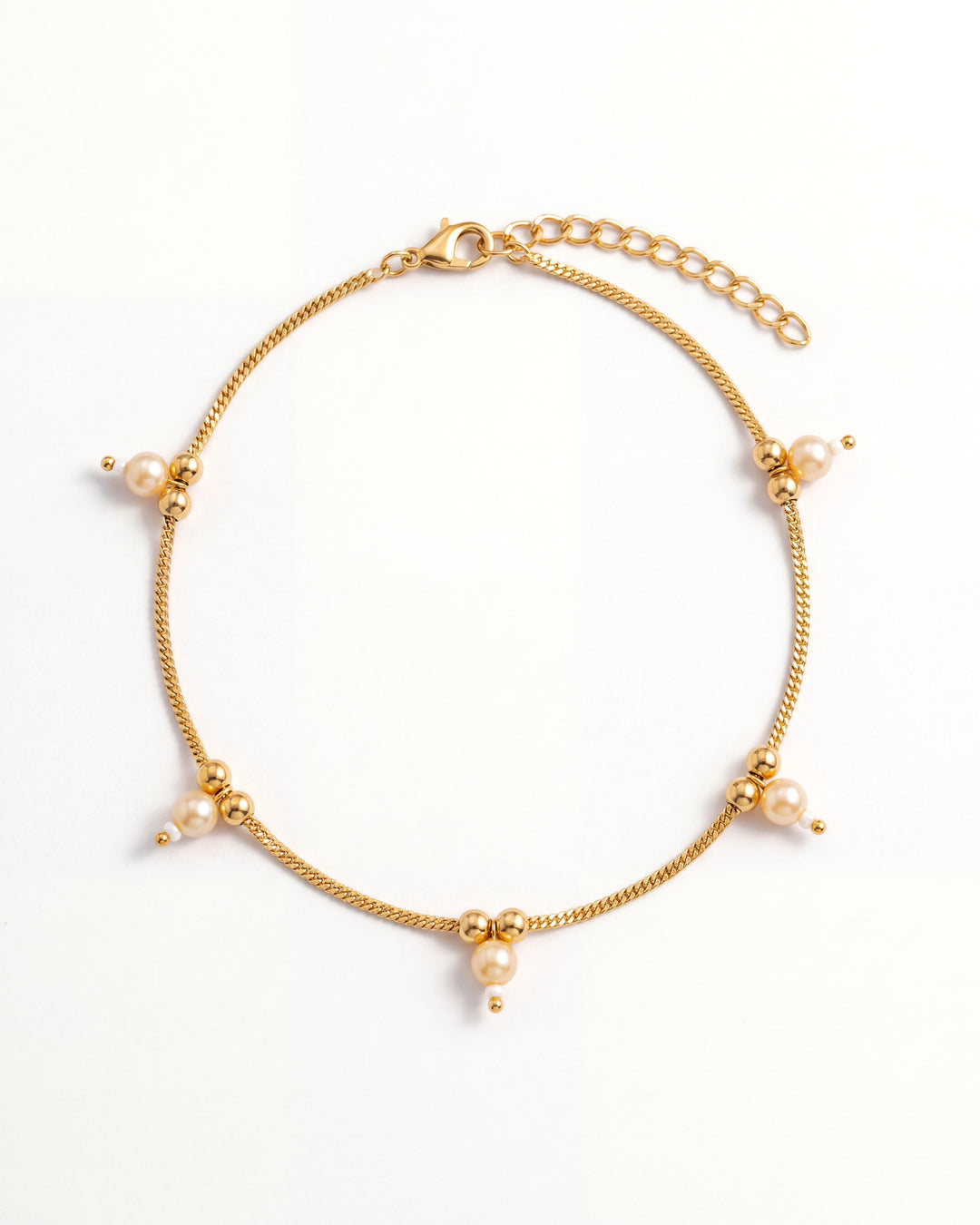 Sia Pearl Anklet laid in an oval, gold-tone chain with cream pearl drops, 2 inch extension and lobster clasp