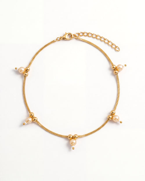 Sia Pearl Anklet laid in an oval, gold-tone chain with cream pearl drops, 2 inch extension and lobster clasp