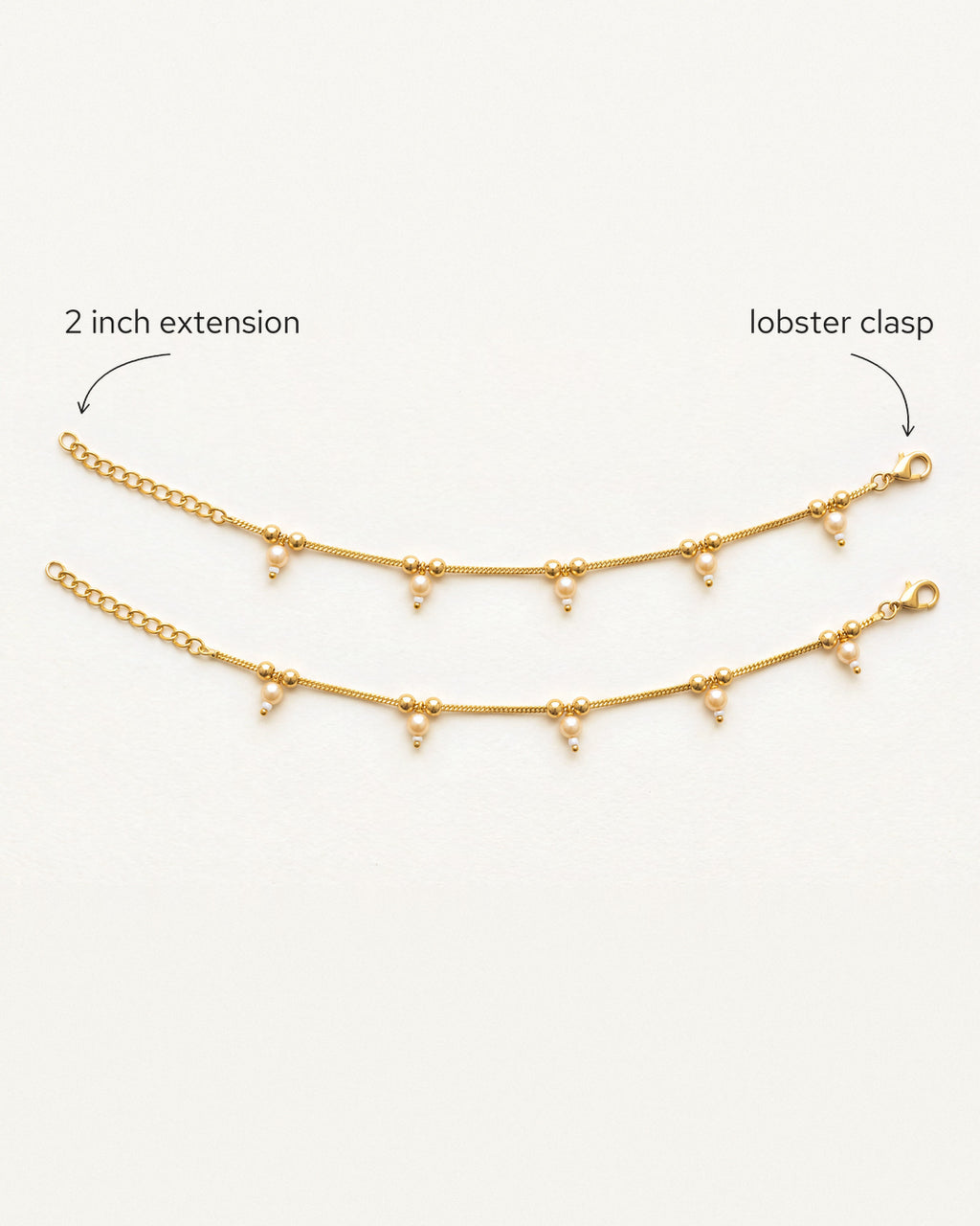 Flat lay of matching Sia Pearl Anklets with labeled 2 inch extension and lobster clasp