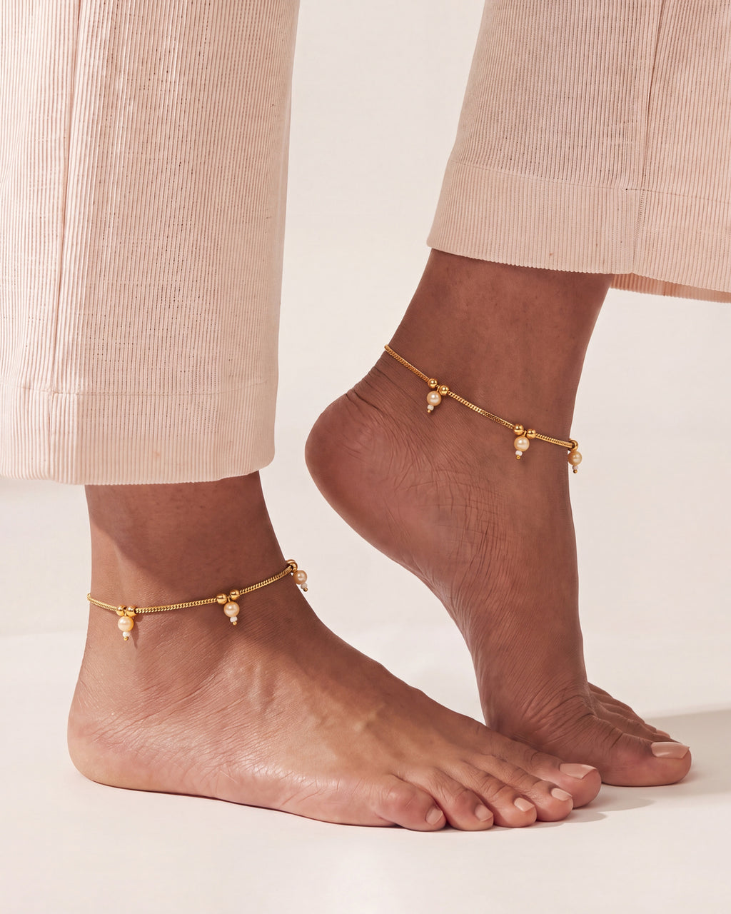 Matching Sia Pearl Anklets worn as a pair, gold-tone chain with cream pearl drops