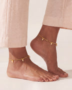 Matching Sia Pearl Anklets worn as a pair, gold-tone chain with cream pearl drops