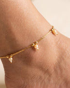 Close detail of Sia Pearl Anklets with cream pearl drops and gold bead details