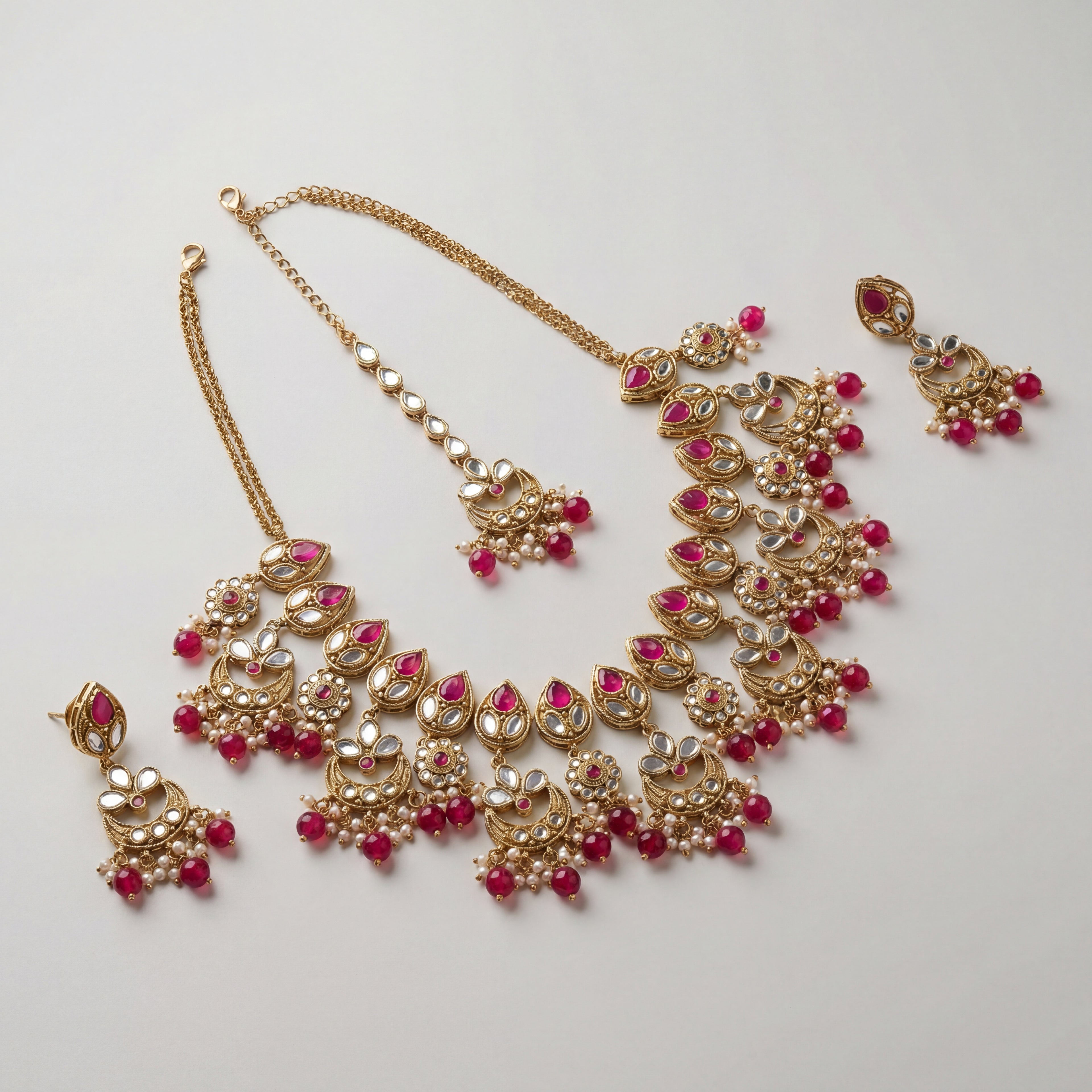 Rani Necklace Set detail showing pink teardrop stones, mirror-work, and pearl-and-bead fringe
