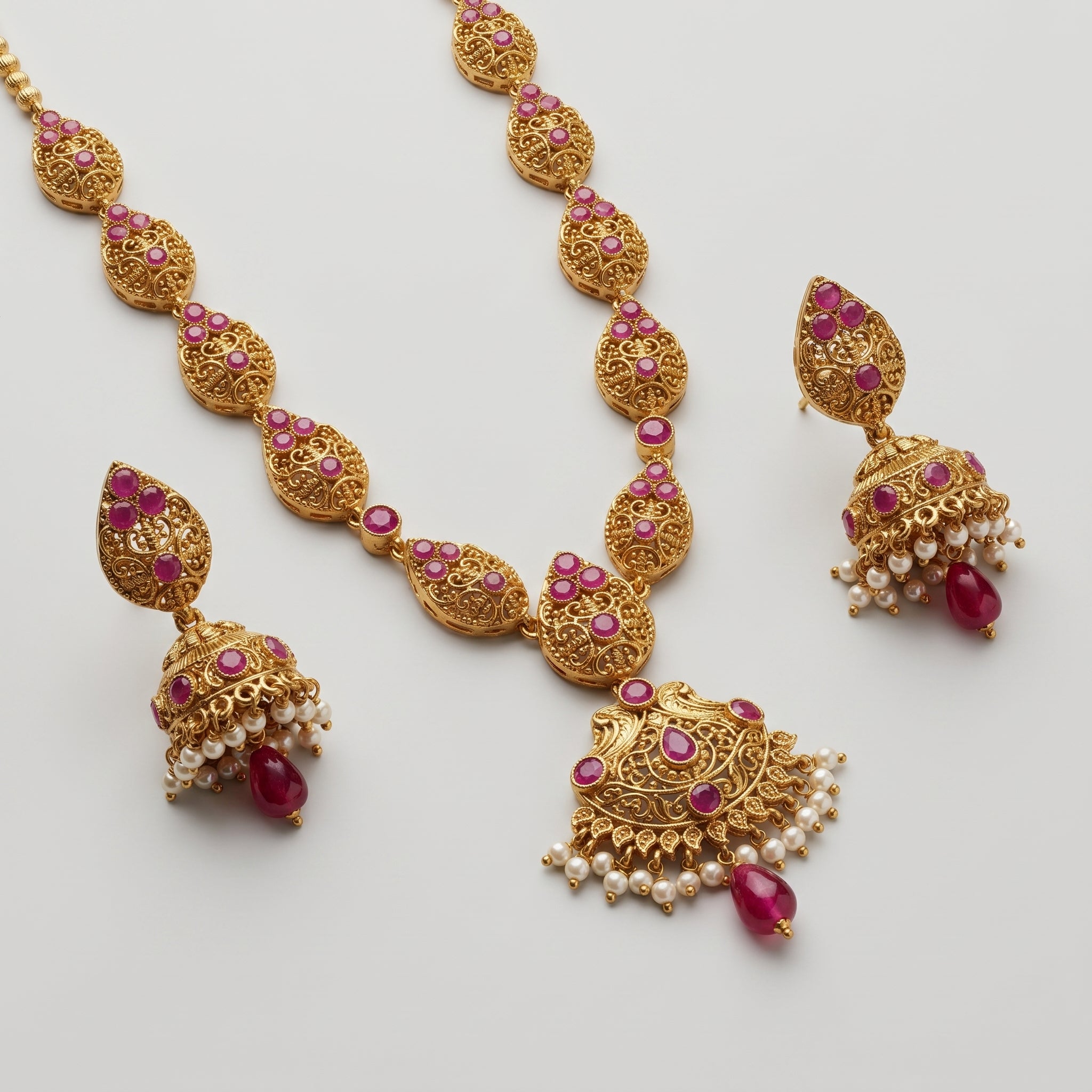 Ruby Pearl Earrings detail showing ruby leaf stud, filigree bell band, and center ruby drop
