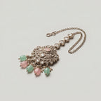 Mridul Tikka detail showing pavé pendant, pink oval stone, and alternating green pink bead drops