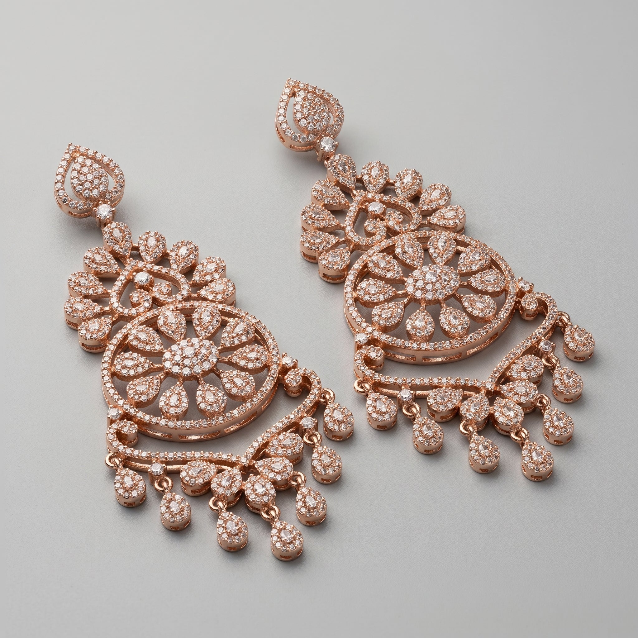 Roshni Earrings detail showing sunburst floral center, heart filigree tiers, and pavé crystal dangles