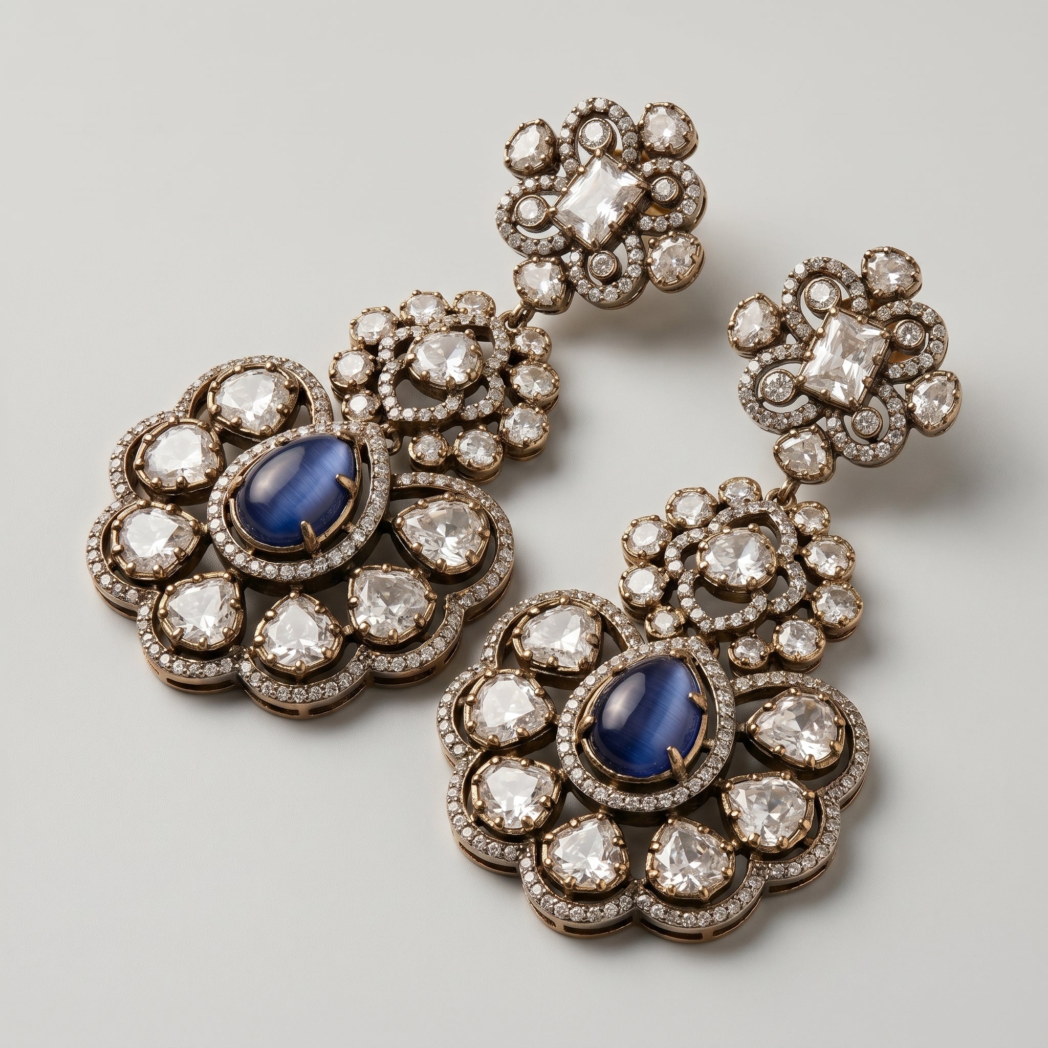 Neelam Bloom Earrings detail showing midnight blue cat's eye center, rose-cut crystal petals, and floral pavé halo
