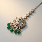 Noor Emerald Tikka detail showing clear crystal chain, pavé circle, and emerald-green drop beads