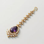 Rani Amethyst Tikka gold-tone maang tikka with purple pear pendant on gray background
