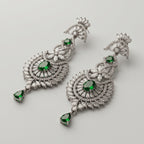 Divya Emerald Earrings detail showing baguette fan top sunburst medallion and green pear drop