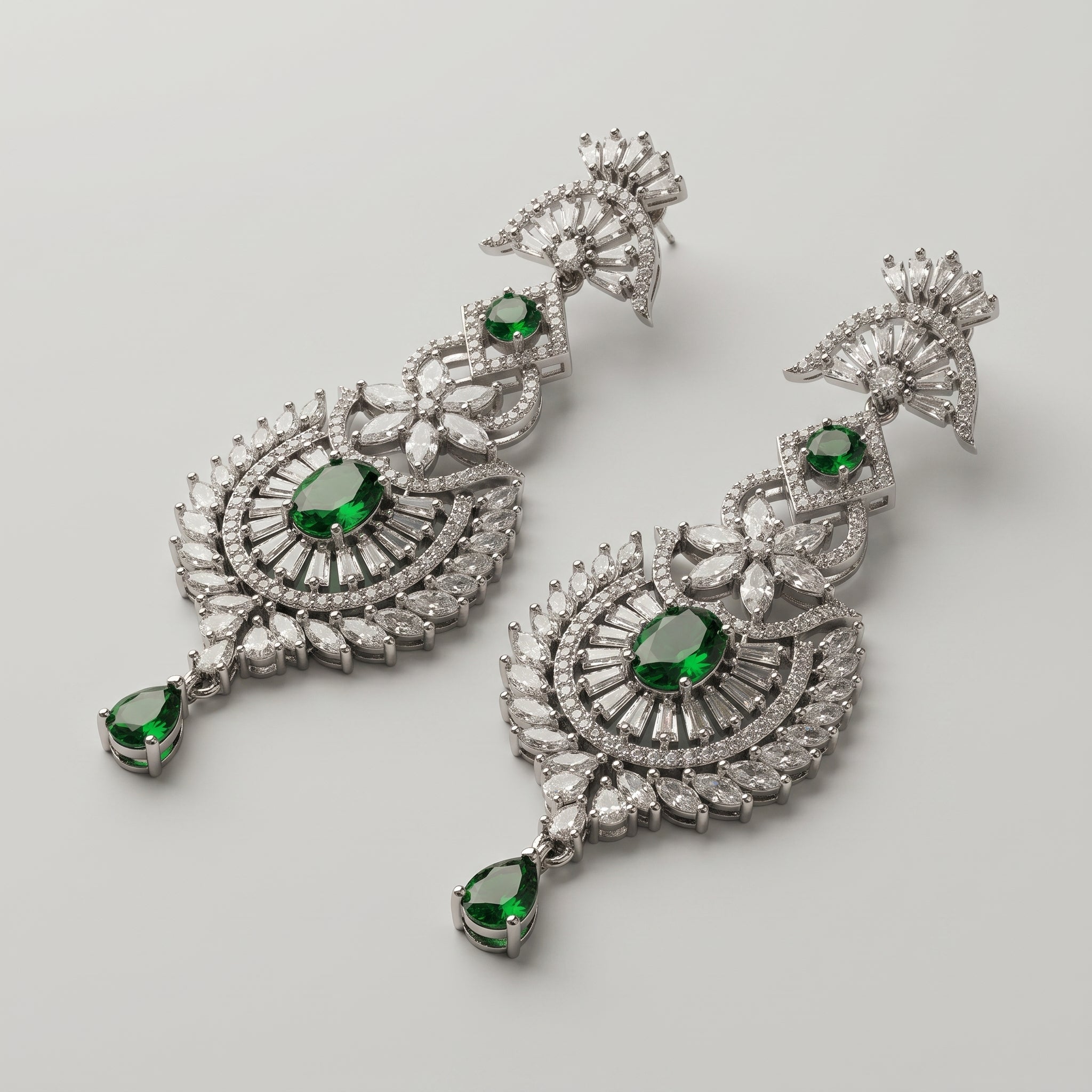 Divya Emerald Earrings detail showing baguette fan top sunburst medallion and green pear drop