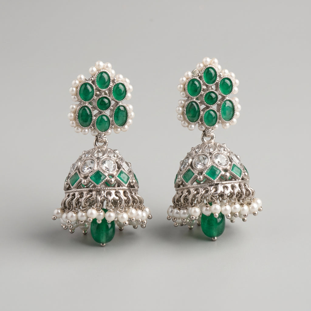Rani Emerald Jhumka Earrings detail showing green cabochon stud, engraved bell, and pearl and emerald drops