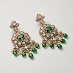 Rani Drop Earrings detail showing emerald-green oval center, pavé scalloped border, and green teardrop pearl fringe