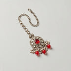 Ruby Bloom Tikka detail showing clear crystal chain, red center medallion, and dangling red beads