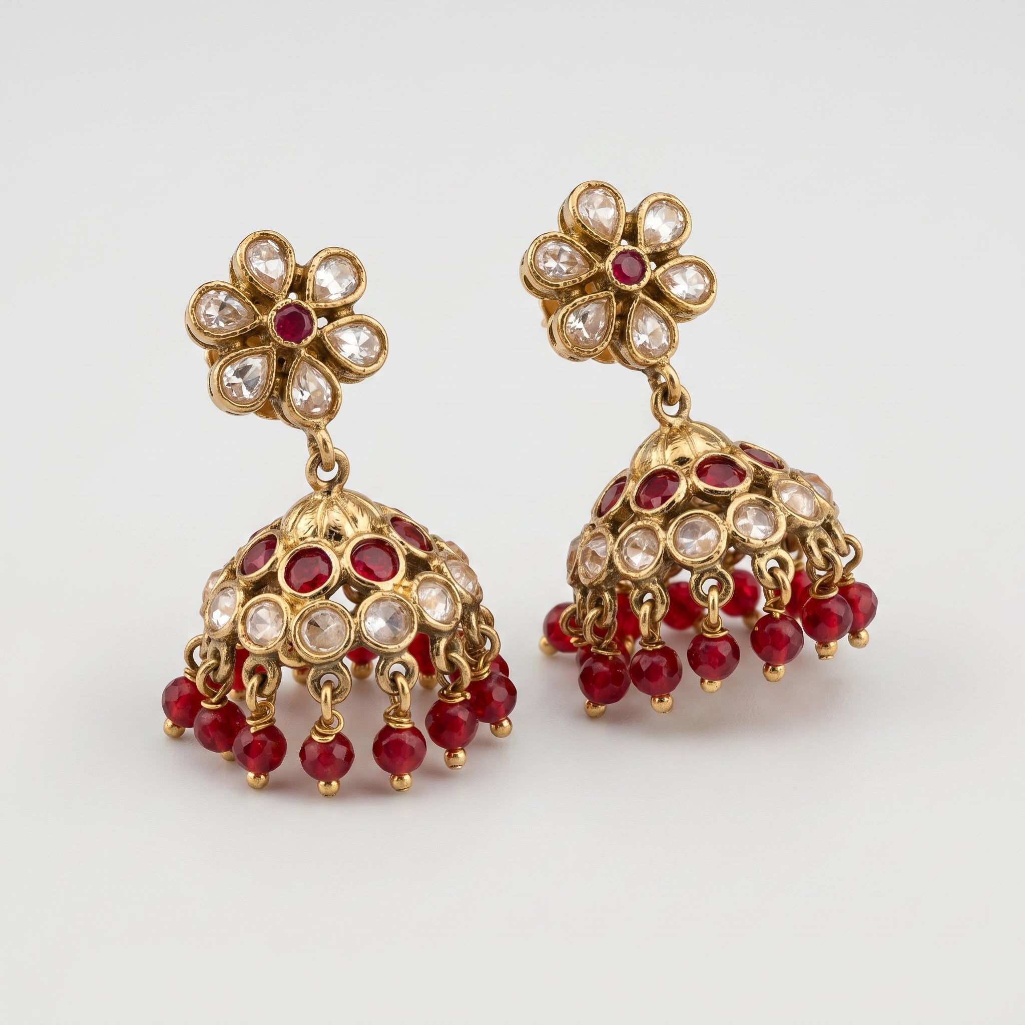 Amrita Ruby Earrings detail showing floral polki stud and ruby bead fringe on the bell