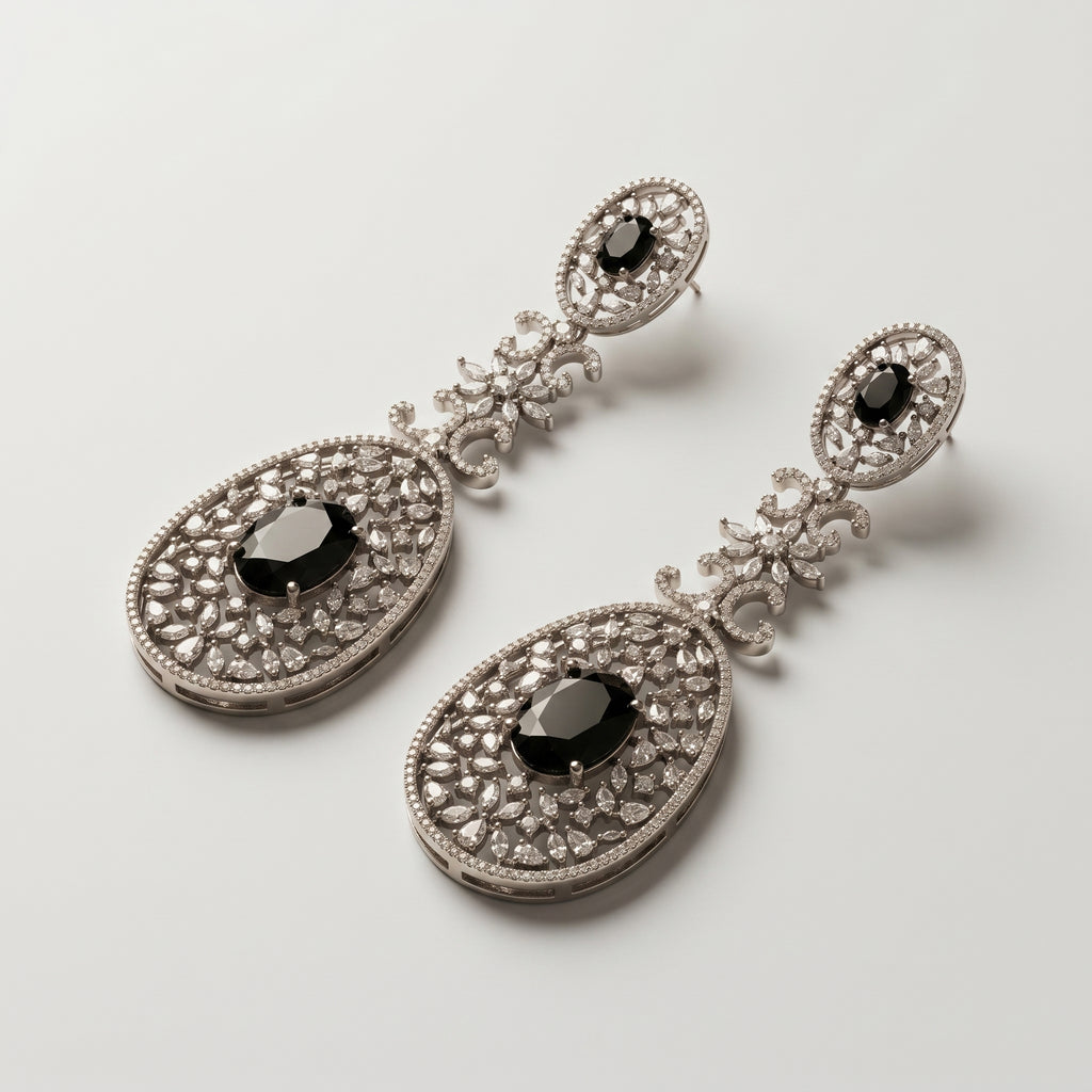 Zara Onyx Earrings detail showing oval black onyx stones, marquise crystal floral link, and pavé lace filigree