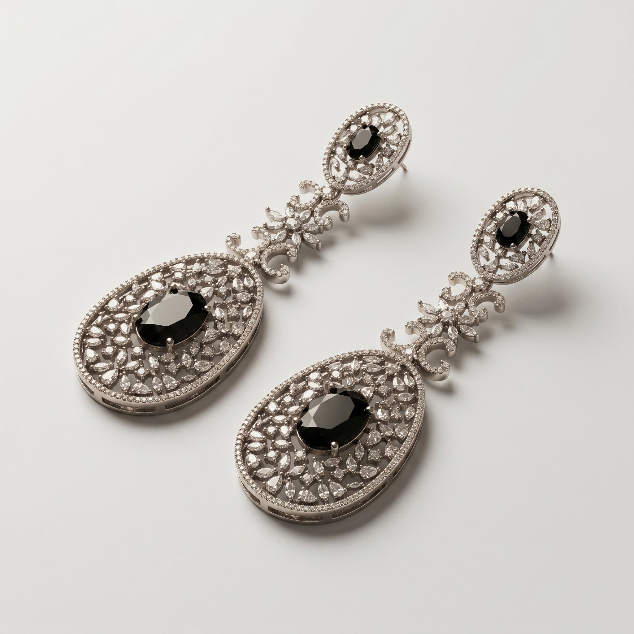 Zara Onyx Earrings detail showing oval black onyx stones, marquise crystal floral link, and pavé lace filigree