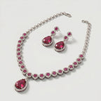Aira Ruby Necklace Set detail showing halo-set round rubies and pear-cut drop pendant