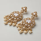 Rani Pearl Earrings detail showing lavender-purple oval center, polki crystal halo, and cream pearl dangles