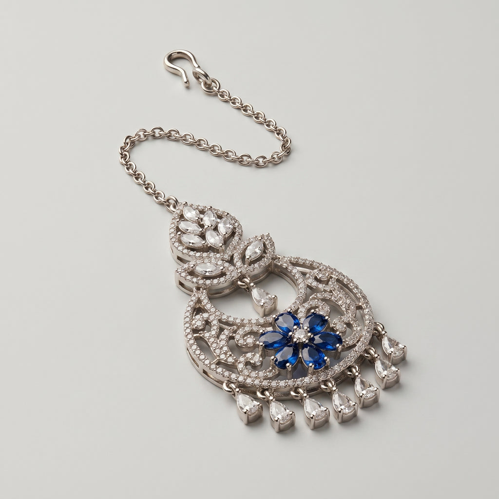 Adah Sapphire Tikka detail showing filigree round frame, blue stone flower, and crystal fringe