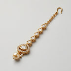 Noor Golden Tikka detail showing teardrop chain triangular halo and pearl cluster
