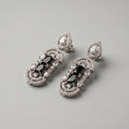 Aira Onyx Earrings detail showing stacked onyx center, pavé arches, and pear crystal accents