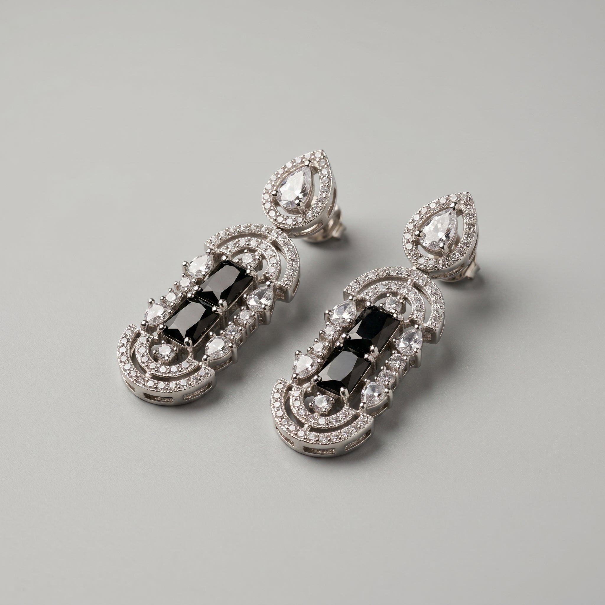 Aira Onyx Earrings detail showing stacked onyx center, pavé arches, and pear crystal accents