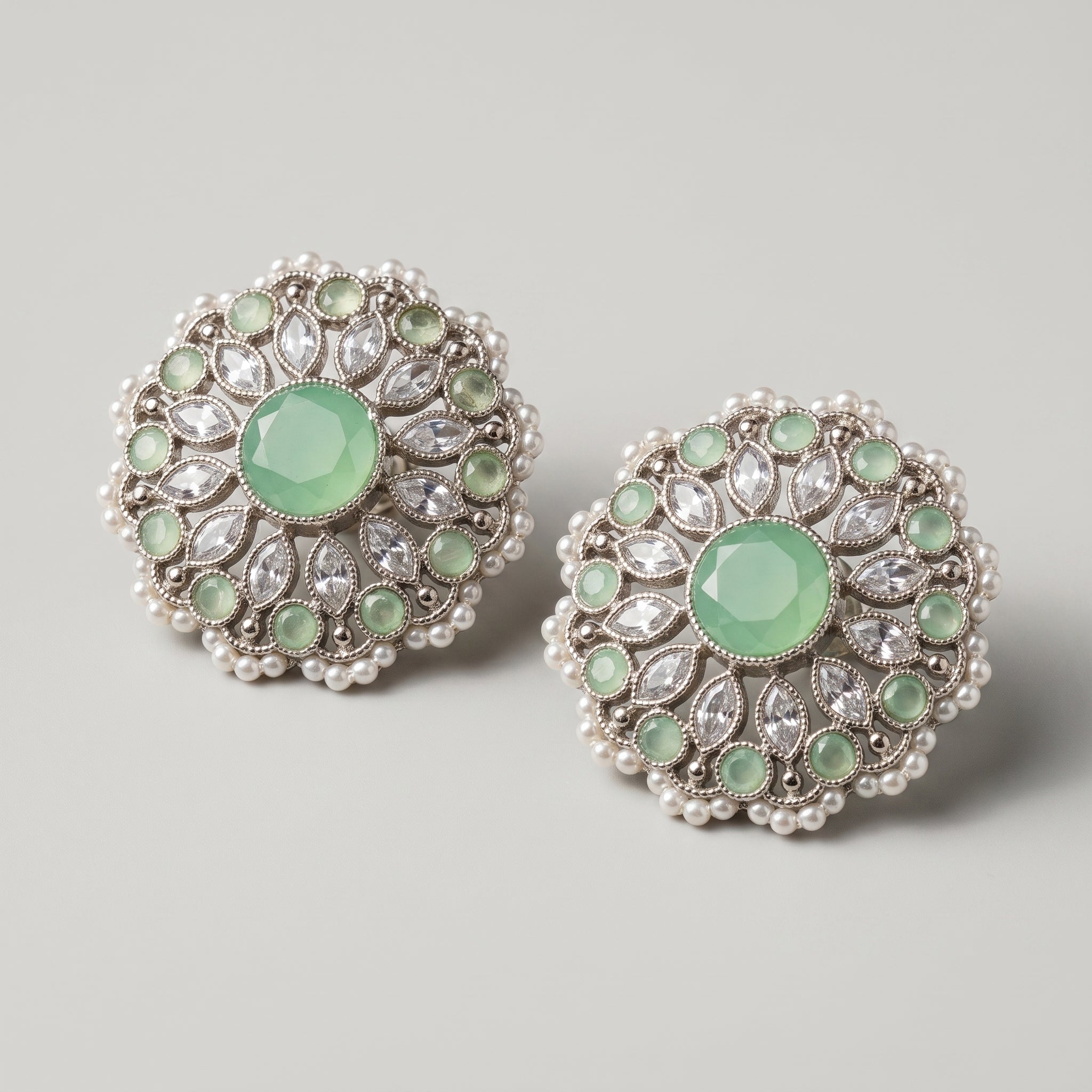 Mint Bloom Earrings detail showing marquise clear crystals, green cabochon ring, and pearl edge