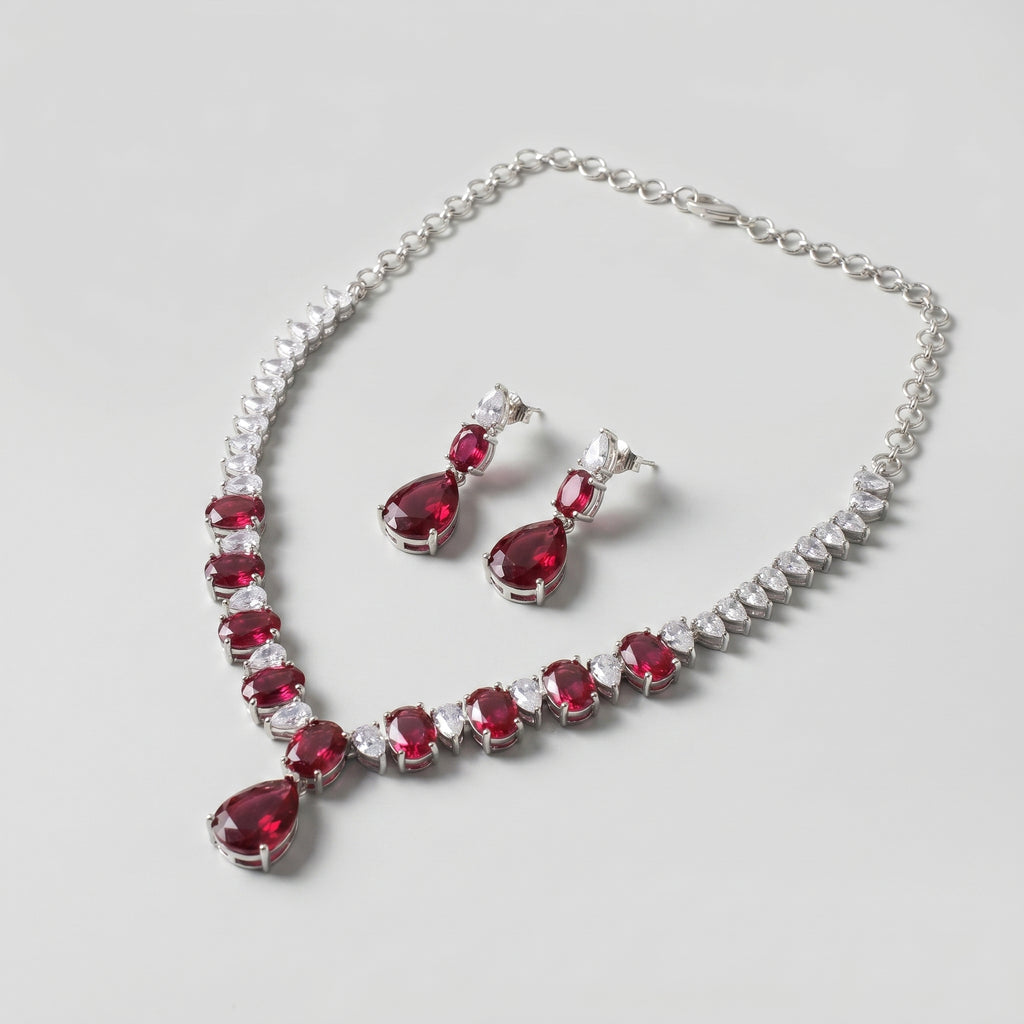 Rani Ruby Necklace Set detail of graduated ruby stones and clear teardrop accent border