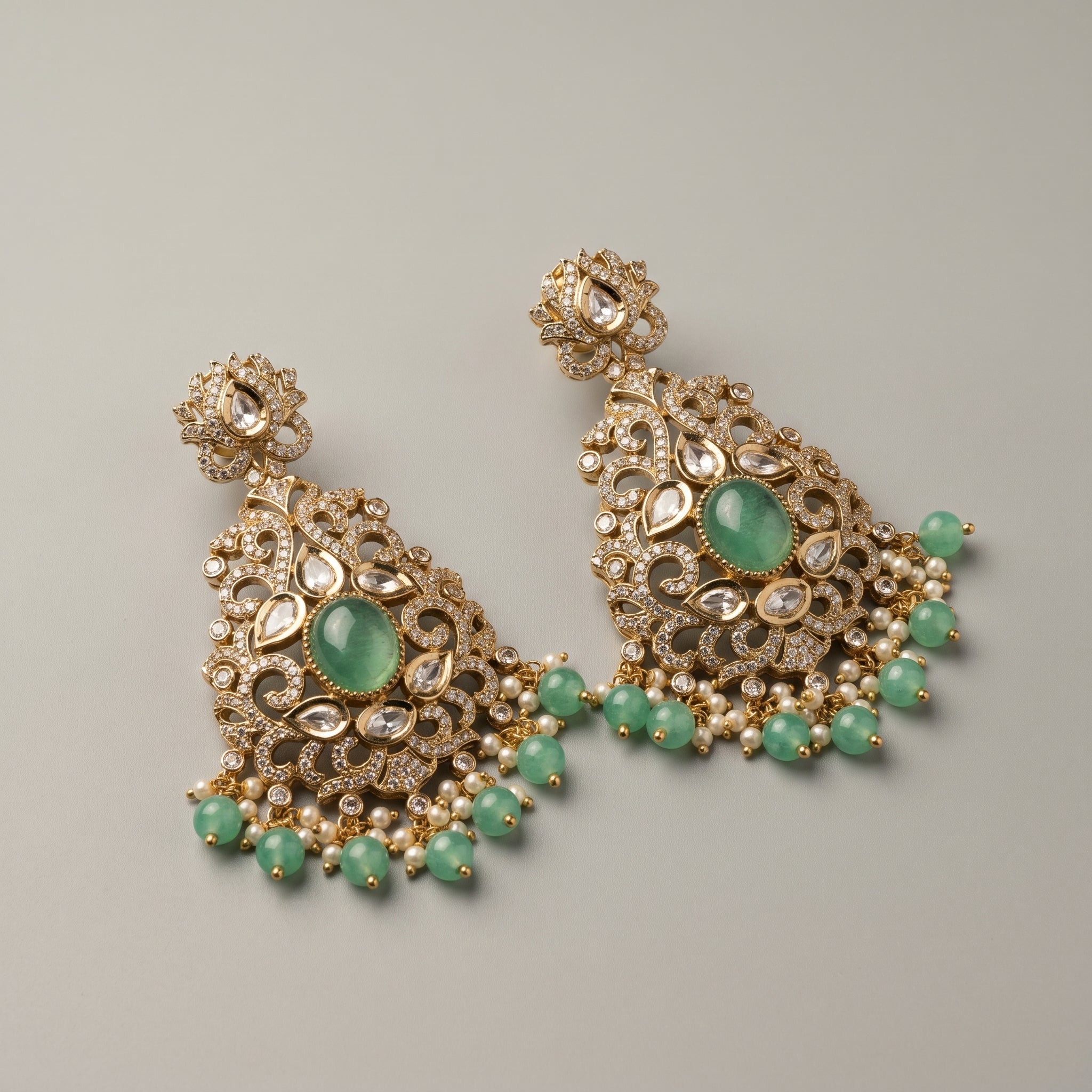 Zara Mint Earrings detail showing milky mint-green center stone, pavé filigree frame, and green bead pearl dangles