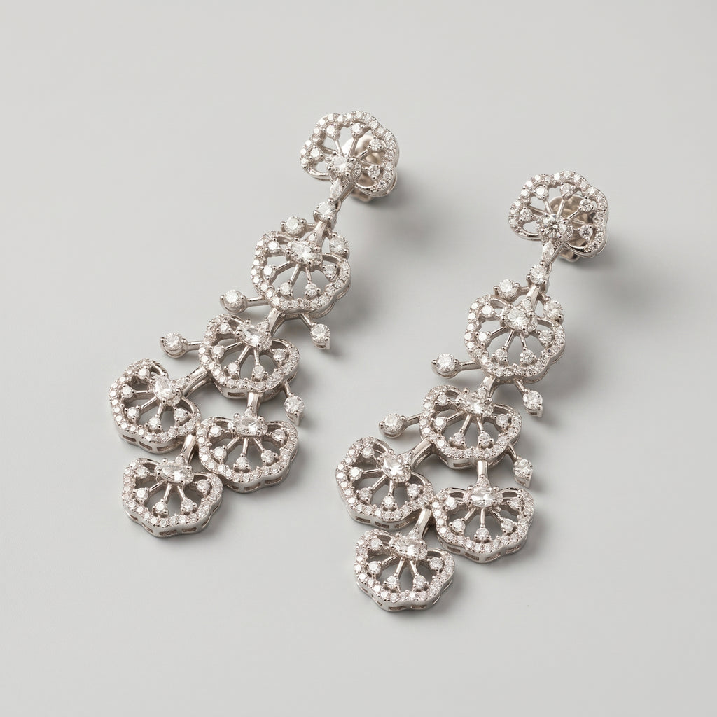 Noor Cascade Earrings detail showing scalloped fan tiers and radiating clear stone spokes