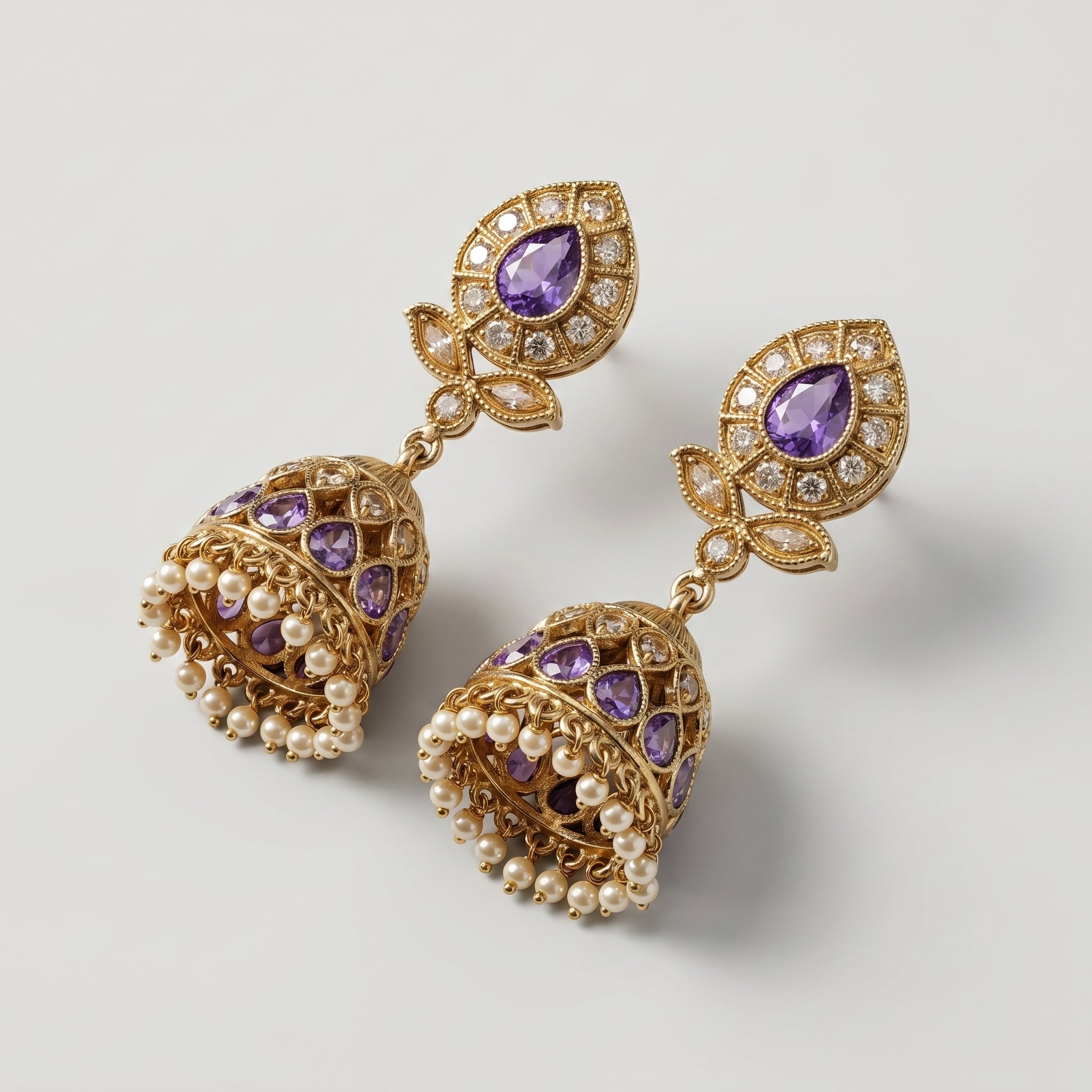 Amethyst Jhumka Earrings gold-tone bell jhumkas with purple teardrop stones and pearl fringe on gray background