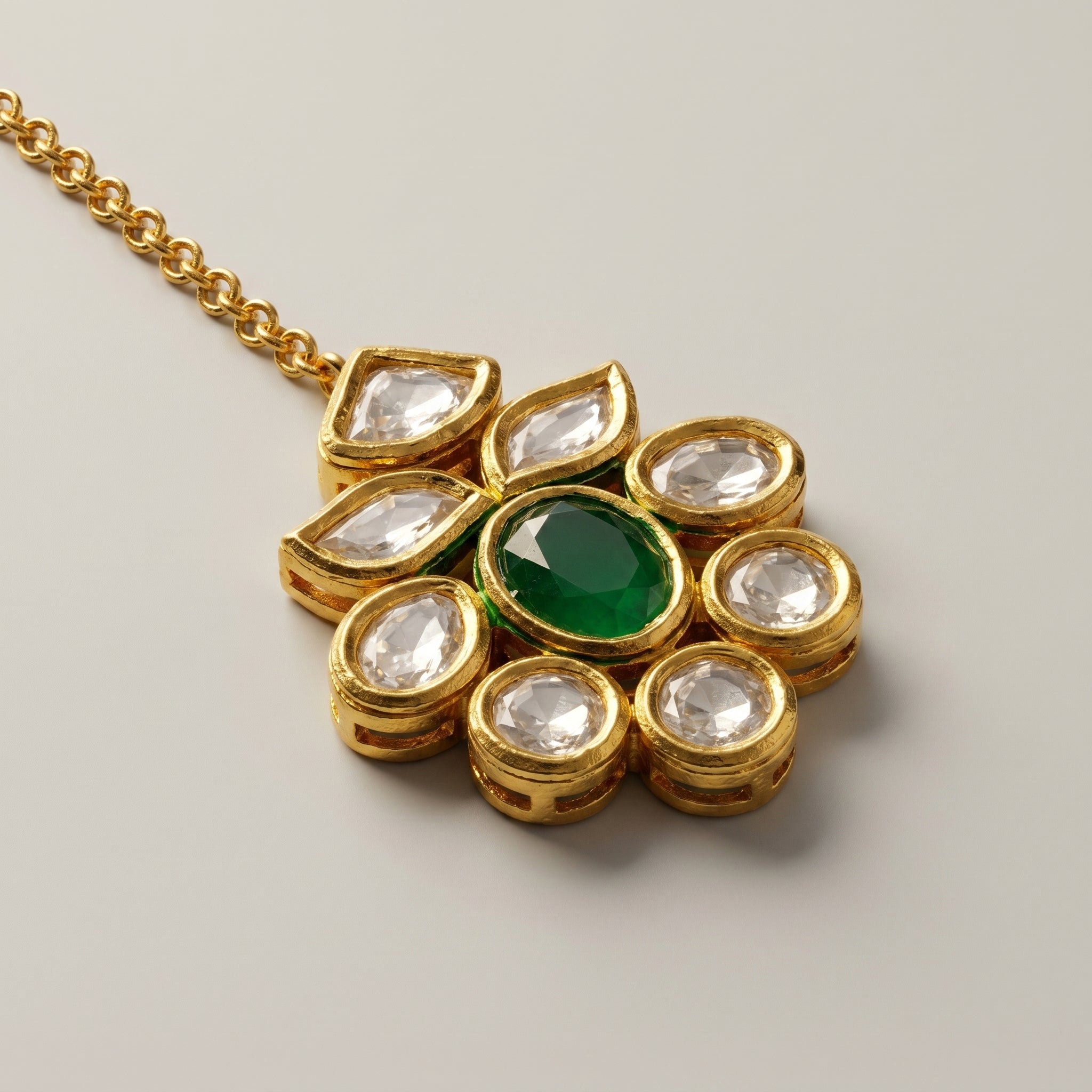Panna Jadau Tikka detail showing oval emerald-green stone and six clear teardrop kundan accents