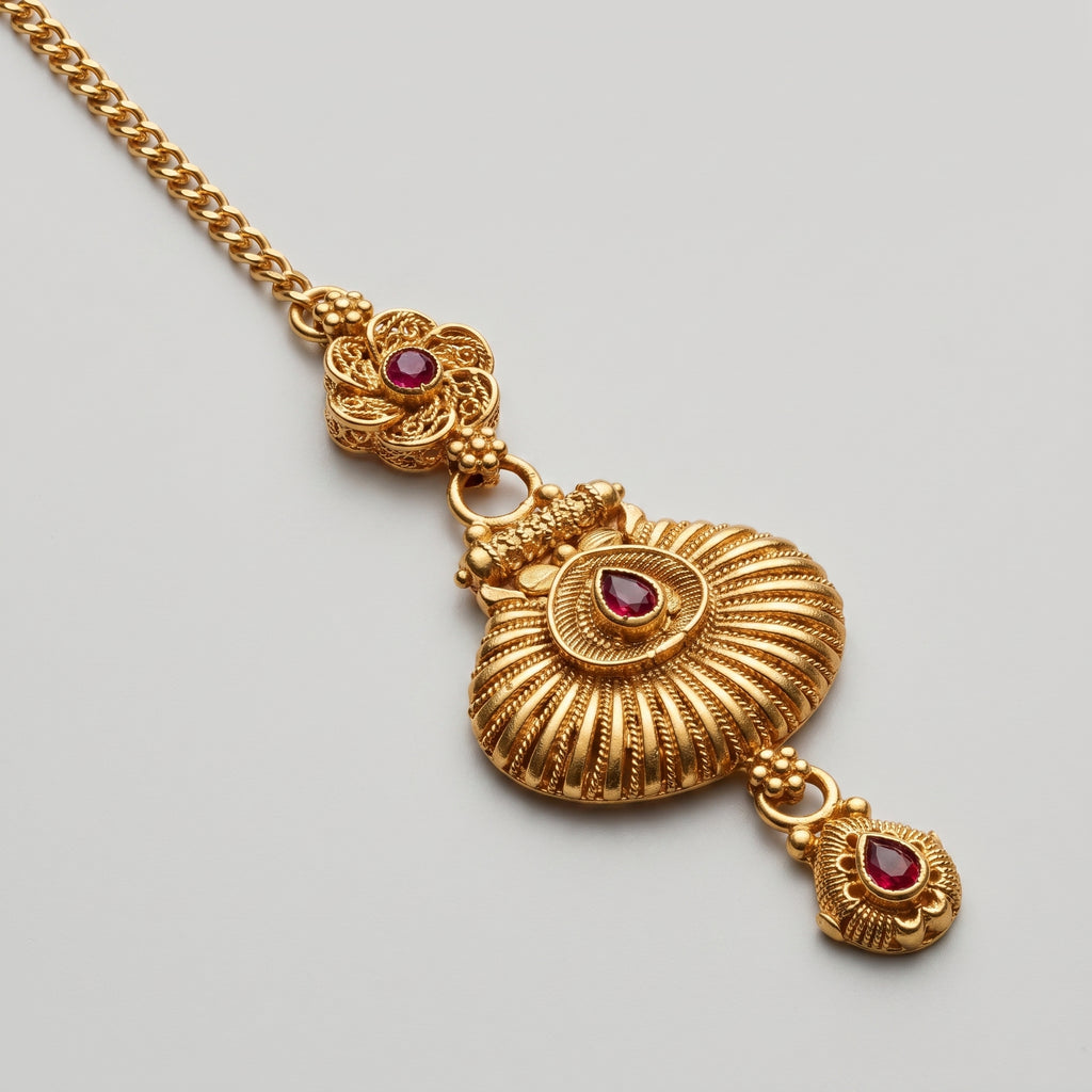 Priya Ruby Tikka detail showing filigree floral connector and ridged fan pendant with teardrop drop